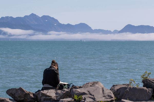 Student studying on a cliffside